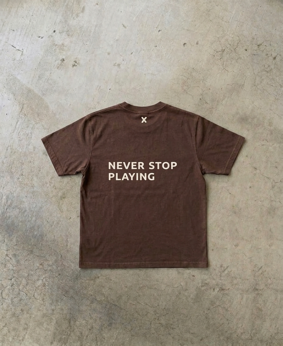 NEVER STOP PLAYING TEE
